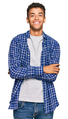 Wall Mural - Young handsome african american man wearing casual clothes happy face smiling with crossed arms looking at the camera. positive person.