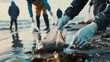 Volunteers hands during a Clean-up Campaign along the beach, preserving coastal environments and marine pollution concept.