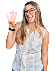 Canvas Print - Hispanic young woman wearing casual white shirt showing and pointing up with fingers number four while smiling confident and happy.