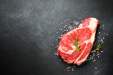 Wall Mural - Beef steak, raw meat on black.