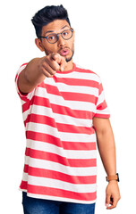 Poster - Handsome latin american young man wearing casual clothes and glasses pointing displeased and frustrated to the camera, angry and furious with you