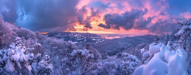 Wall Mural - A vibrant sunset casting warm hues over a snow-covered mountain range, creating a striking contrast between the white snow and colorful sky