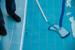 Cleaning the pool. A man cleans the pool