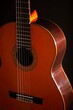 © Robert Peak - Classical Spanish flamenco guitar close up, dramatically lit isolated on black background with copy space.