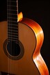 © Robert Peak - Classical Spanish flamenco guitar close up, dramatically lit isolated on black background with copy space.