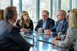 © Ilia Nesolenyi - A group of business professionals engaged in a negotiation or discussion around a conference table in an office setting