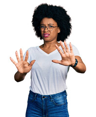 Sticker - Young african american woman wearing casual white t shirt doing stop gesture with hands palms, angry and frustration expression