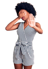 Poster - Young african american woman wearing casual clothes covering eyes with hands and doing stop gesture with sad and fear expression. embarrassed and negative concept.