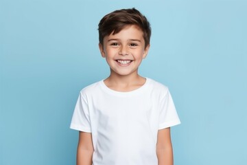 young boy in white shirt smiling