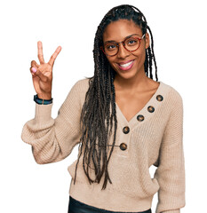 Wall Mural - African american woman wearing casual clothes smiling looking to the camera showing fingers doing victory sign. number two.