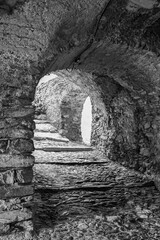 Poster - Black and white photo. Uphill stone arcade in the 