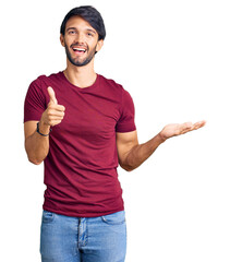 Canvas Print - Handsome hispanic man wearing casual clothes showing palm hand and doing ok gesture with thumbs up, smiling happy and cheerful