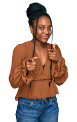 Wall Mural - Young african american woman wearing casual clothes pointing fingers to camera with happy and funny face. good energy and vibes.