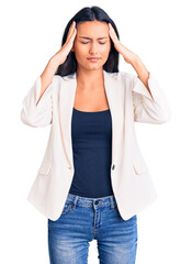 Canvas Print - Young beautiful latin girl wearing business clothes suffering from headache desperate and stressed because pain and migraine. hands on head.