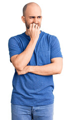 Poster - Young handsome man wearing casual t shirt looking stressed and nervous with hands on mouth biting nails. anxiety problem.