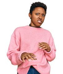 Wall Mural - Young african american woman wearing casual clothes disgusted expression, displeased and fearful doing disgust face because aversion reaction. with hands raised