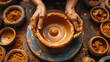 top view of hands making a clay pot on a potter's wheel, craft, hobby, workshop, studio, handmade, ceramics, craft, creativity, person, artist, sculptor, potter