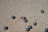 Fototapeta Tulipany - Playing a game of boules bocce ball (also called pétanque) in Provence, France