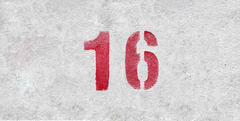 Red Number 16 on the white wall. Spray paint.