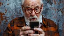 An Elderly Gentleman Or Boomer Looking At His Cell Phone. He Is Either Surprised By The Technology Or Found Something That Surprises Him And Old Man Playing A Game On A Cell Phone.