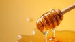 honey dripping from a wooden spoon on yellow studio background 