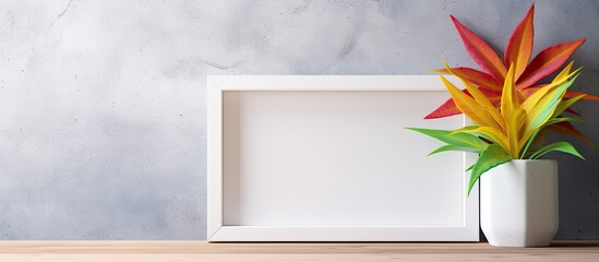 Poster - a rectangular picture frame with a potted plant sits on a wooden table. the delicate petals and twig