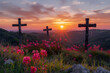 Three beautiful, flowery crosses on a hillside with a beautiful sunrise in the background.