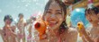 candid Asian people are using water guns play songkran festival in the summer april