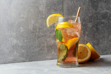 Wall Mural - Iced tea with mint and lemon on a grey background.