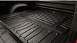 A durable rubber bed liner, custom-molded to fit the contours of the truck bed, protecting against scratches and dents