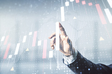 Poster - Multi exposure of businessman hand working with virtual creative financial graph and world map on blurred office background, forex and investment concept