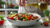 Woman adding olive oil to fresh vegetable salad on table