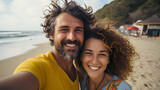 Fototapeta Do akwarium - happy smiling couple taking selfie at the beach with smiling faces