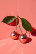 Cherries fruit adorned with disco ball mirror. Surreal Summer fruit aesthetic retro idea. Red background.