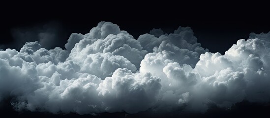 Wall Mural - a cumulus cloud gracefully floats in the electric blue sky against a dark background, creating a str