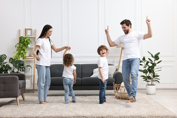 Canvas Print - Happy family dancing and having fun in living room