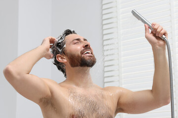 Poster - Happy man washing his hair with shampoo in shower