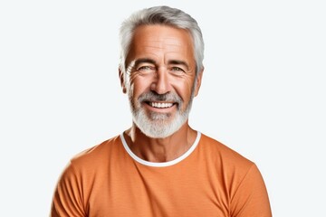 mature man with grey hair and beard in orange shirt