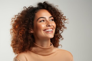 Canvas Print - Smiling Woman With Curly Hair in Turtle Neck Sweater