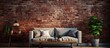 The living room features a charming brick wall with a comfortable couch, creating a cozy atmosphere. The brickwork adds texture to the space