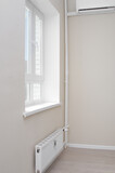 Fototapeta Uliczki - Empty light  flat with window and modern radiator