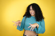 African american woman wearing casual sweater over yellow background disgusted expression, displeased and fearful doing disgust face because aversion reaction.Annoying concept