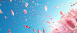 Mesmerizing view of delicate pink petals from cherry blossoms swirling in the air against a bright blue sky background