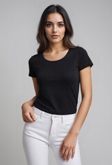 Wall Mural - Brunette young woman wearing white pants and blank black t-shirt with copy space for text, logo, branding, print design. Front view. Attractive female model poses in black t-shirt in photo studio.