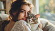 Gorgeous young lady relaxing at home with a lovely cat 