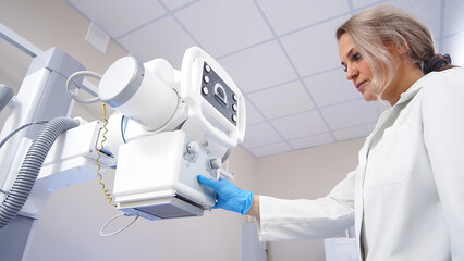 Sticker - A specialist radiologist doctor installs an x-ray scanner for a patient. Medical research, injury and treatment concept.