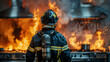 Back view of a firefighter in full gear watching a fierce blaze, concept of bravery, emergency response, and fire safety