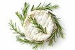 Camembert cheese with sprigs of rosemary on a white isolated background