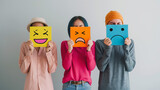 Fototapeta  - People holding up emoticon cardboard cutouts of smiles, frowns and sad faces. Customer feedback. Staff survey. Happiness. Moods. Sadness. Frustration.