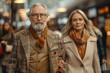 © arti om - full length photo. In a busy airport terminal, a aged couple in a stylish suits with luggages stands out from the throngs of travelers